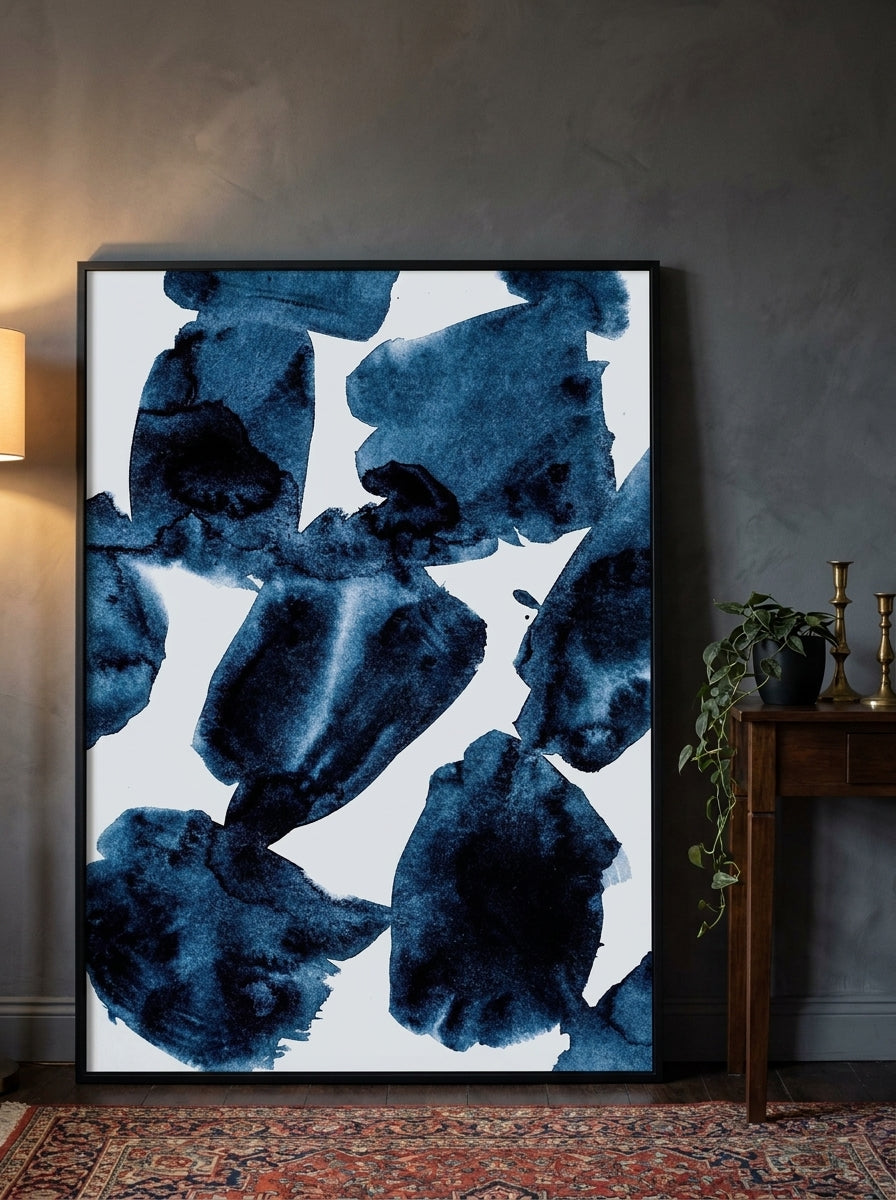 Oversized statement modern wall art print leaning against the wall in a moody bedroom