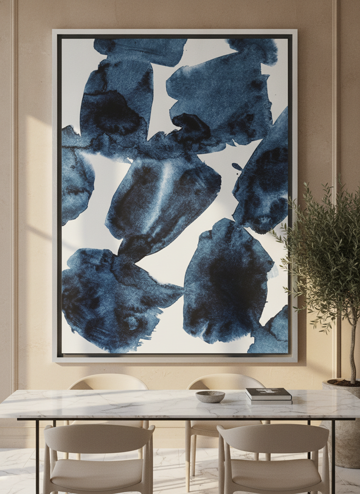 Oversized statement canvas wall art with a silver leaf surround styled on the wall in a luxe dining room