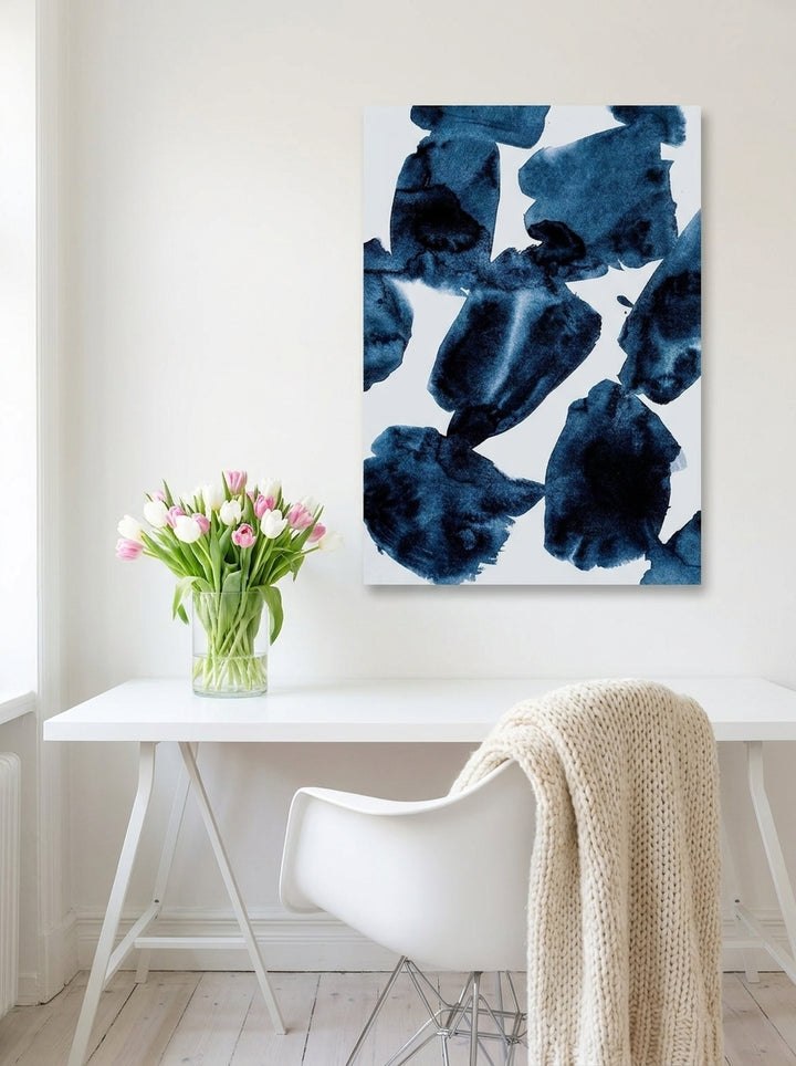 Stretched canvas wall art styled on the wall in a bright Scandinavian home office
