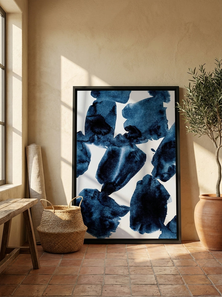 Canvas wall art with a black surround leaning against the wall in a Mediterranean living room