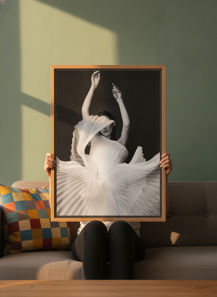 Person holding canvas wall art with a natural timber surround in a colourful eclectic living room