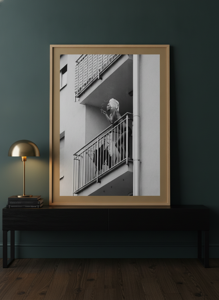 Modern wall art print standing on a console in a moody bedroom