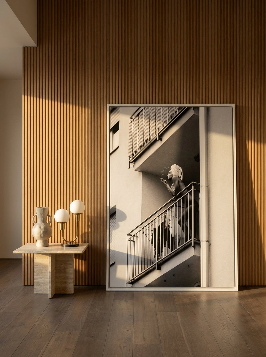 Oversized statement canvas wall art with a white surround leaning against the wall in a luxe dining room