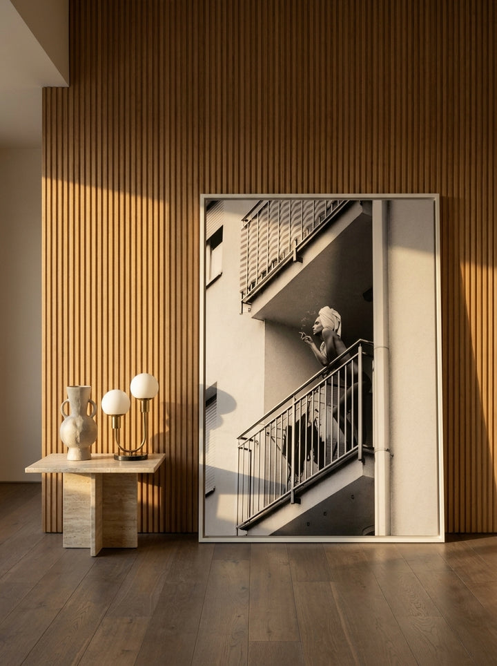 Oversized statement canvas wall art with a white surround leaning against the wall in a luxe dining room