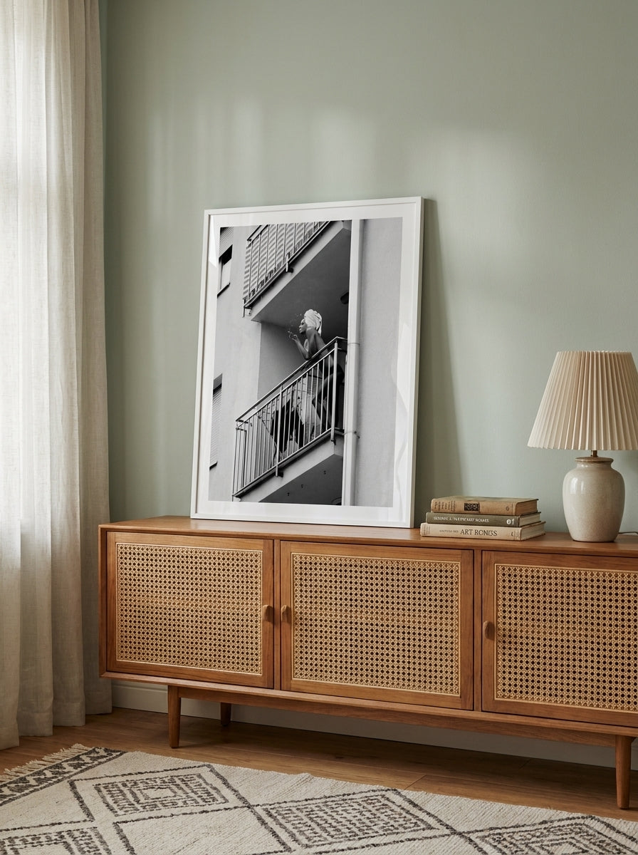 Modern wall art print standing on a sideboard in a mid-century living room