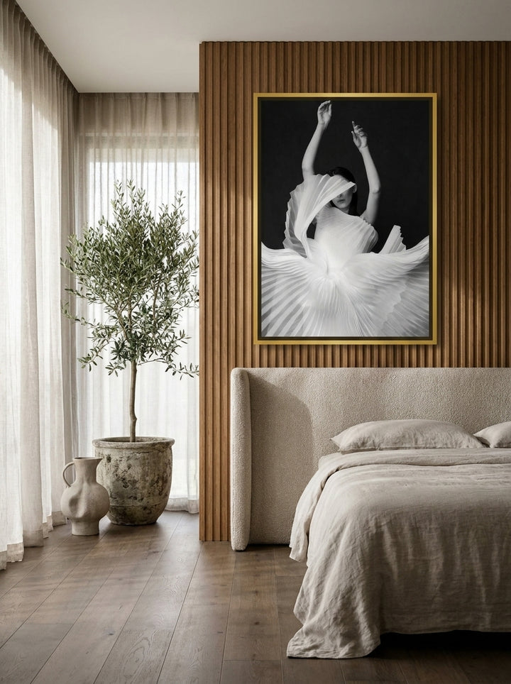 Canvas wall art with a gold leaf surround styled on the wall in a luxe bedroom