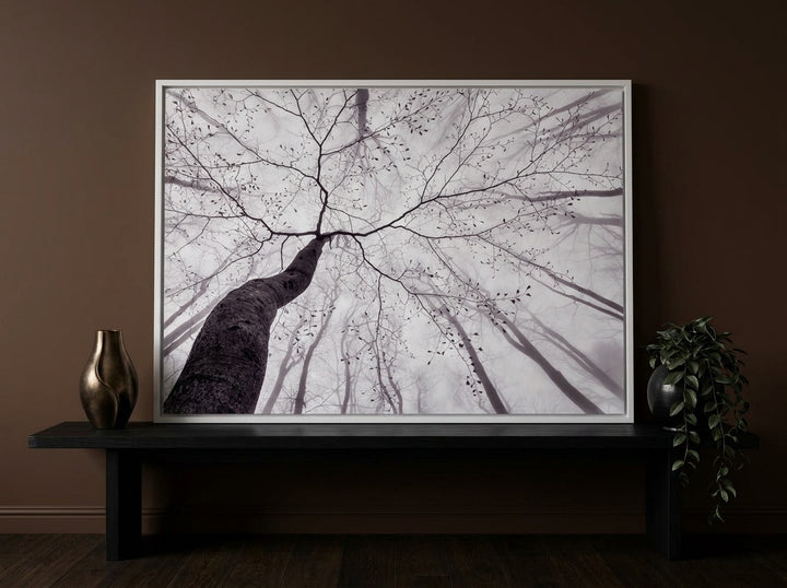 Modern wall art print standing on a console in a moody home office