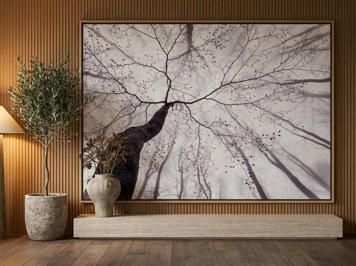 Oversized statement canvas wall art with a natural timber surround styled on the wall in a luxe living room