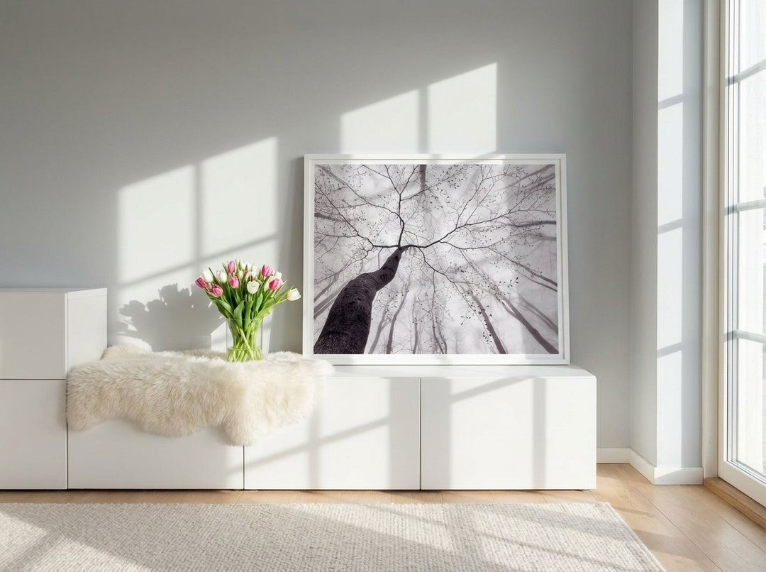 Modern wall art print standing on a sideboard in a bright Scandinavian bedroom
