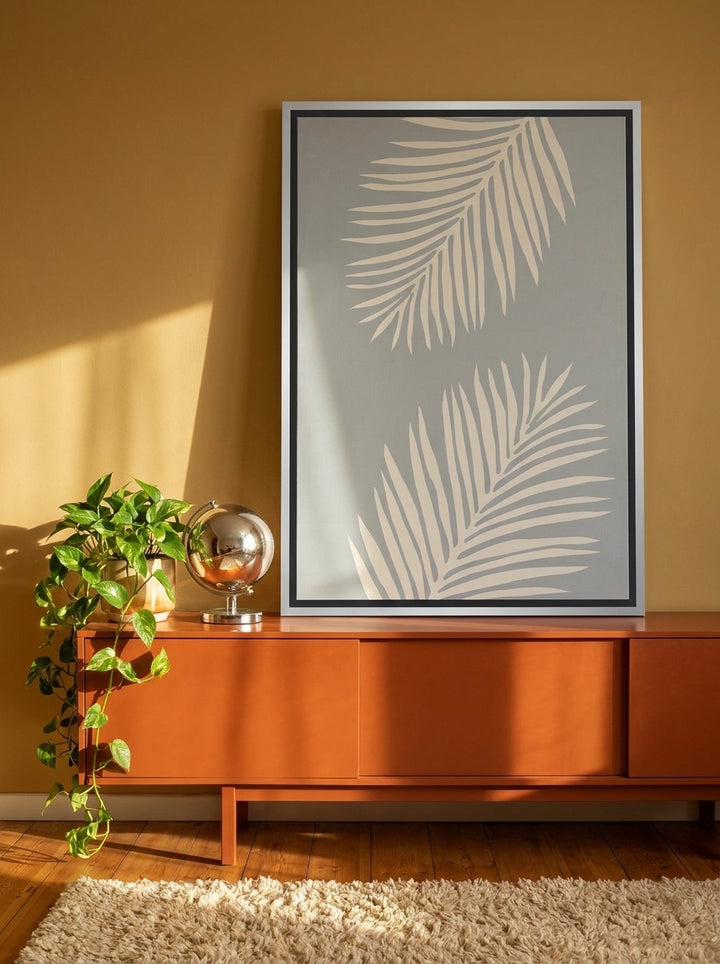 Canvas wall art with a silver leaf surround standing on a sideboard in a retro 70s home office