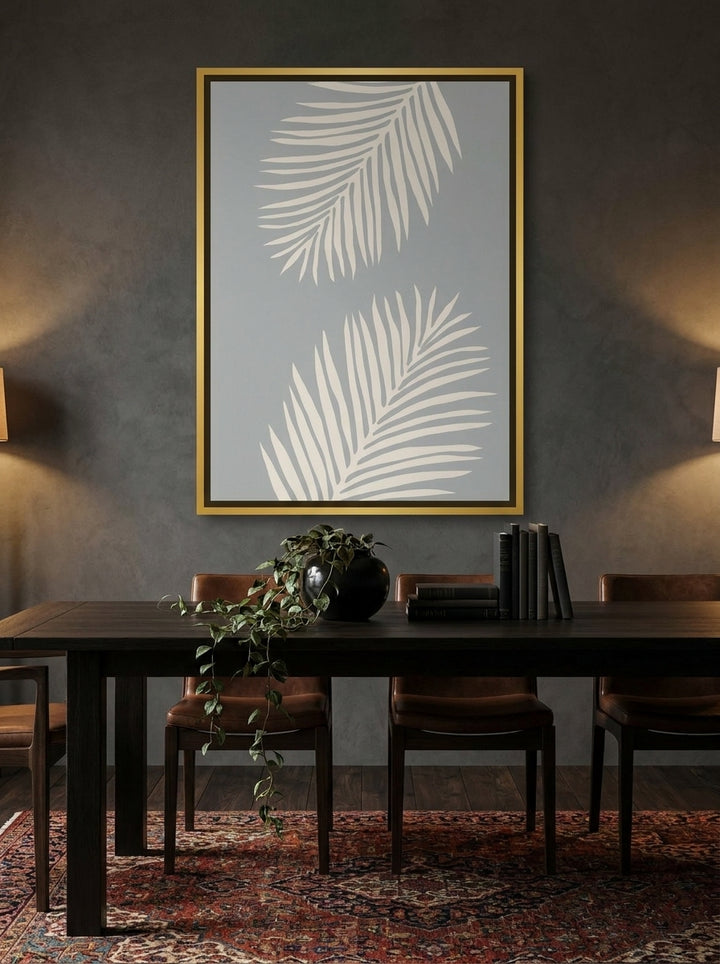 Canvas wall art with a gold leaf surround styled on the wall in a moody dining room
