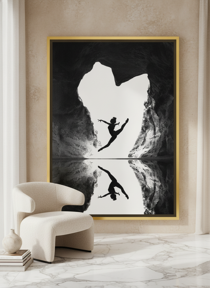Oversized statement canvas wall art with a gold leaf surround leaning against the wall in a luxe living room