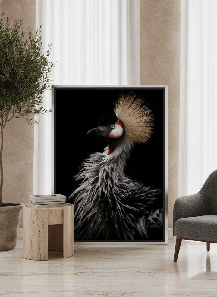 Oversized statement canvas wall art with a silver leaf surround leaning against the wall in a luxe living room