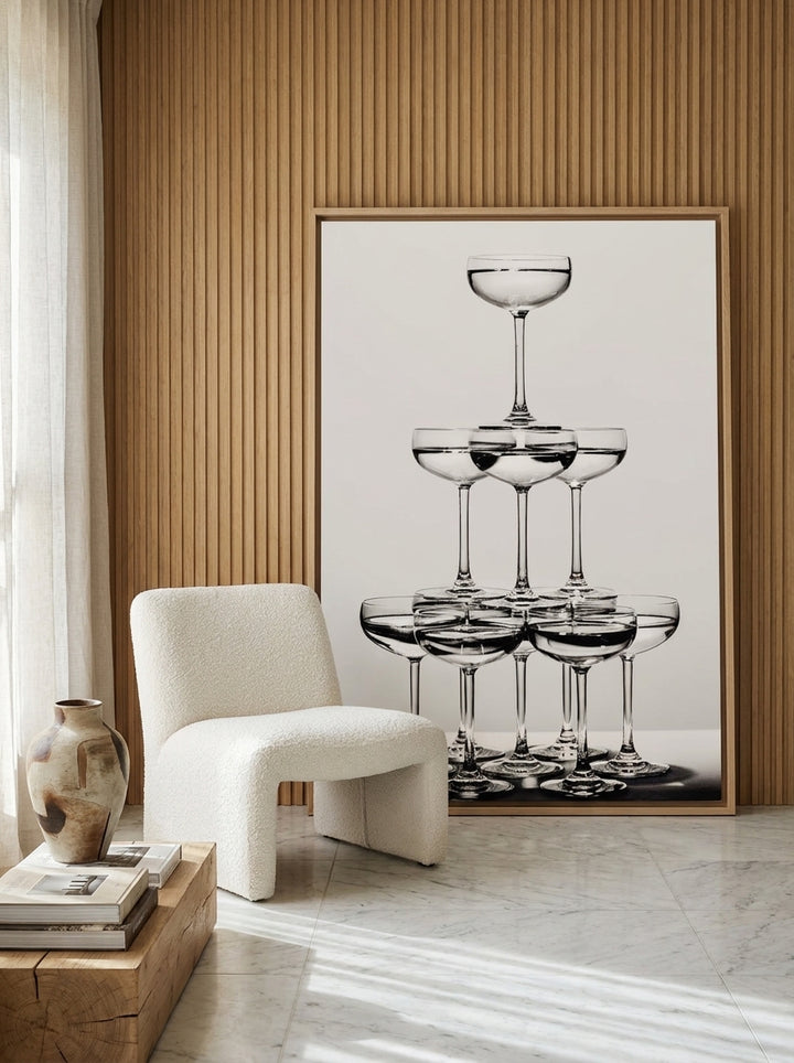 Oversized statement canvas wall art with a natural timber surround leaning against the wall in a luxe dining room