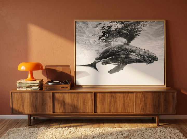 Canvas wall art with a natural timber surround standing on a sideboard in a retro 70s bedroom