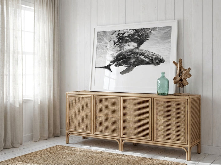 Modern wall art print standing on a sideboard in a coastal bathroom
