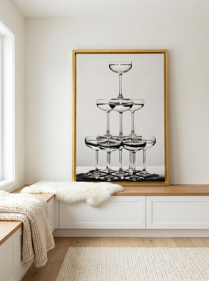 Canvas wall art with a gold leaf surround standing on a kitchen bench in a bright Scandinavian kitchen
