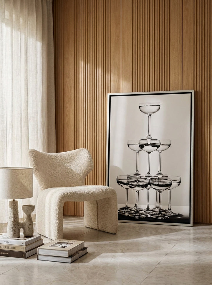 Canvas wall art with a silver leaf surround leaning against the wall in a luxe dining room