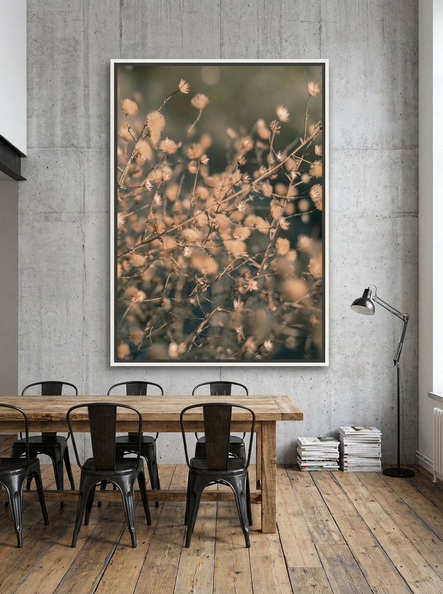 Oversized statement canvas wall art with a white surround styled on the wall in an industrial loft dining room