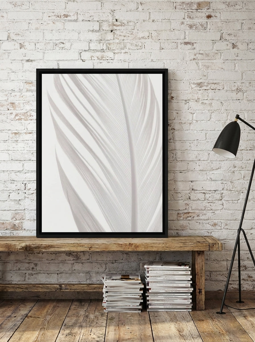 Canvas wall art with a black surround standing on a bench in an industrial loft bedroom