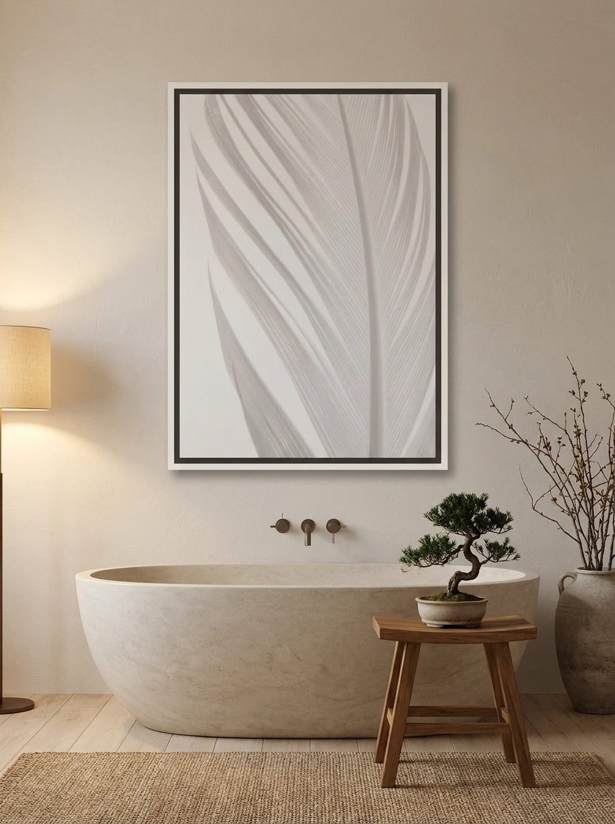 Canvas wall art with a white surround styled on the wall in a warm Japandi bathroom