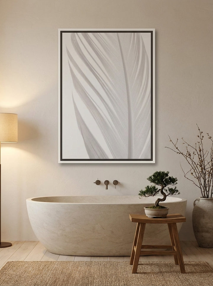 Canvas wall art with a white surround styled on the wall in a warm Japandi bathroom