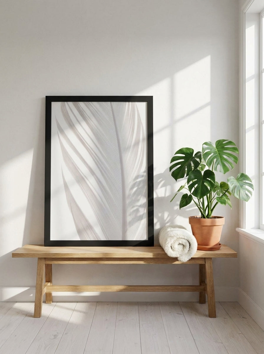 Modern wall art print standing on a bench in a bright Scandinavian bathroom