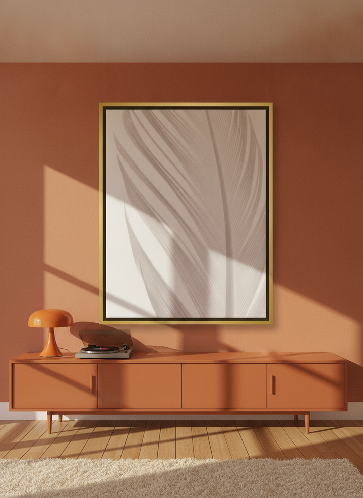 Oversized statement canvas wall art with a gold leaf surround styled on the wall in a retro 70s living room