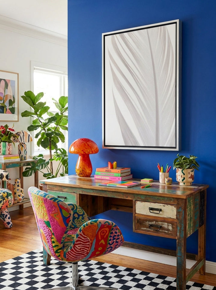 Canvas wall art with a silver leaf surround styled on the wall in a colourful eclectic home office