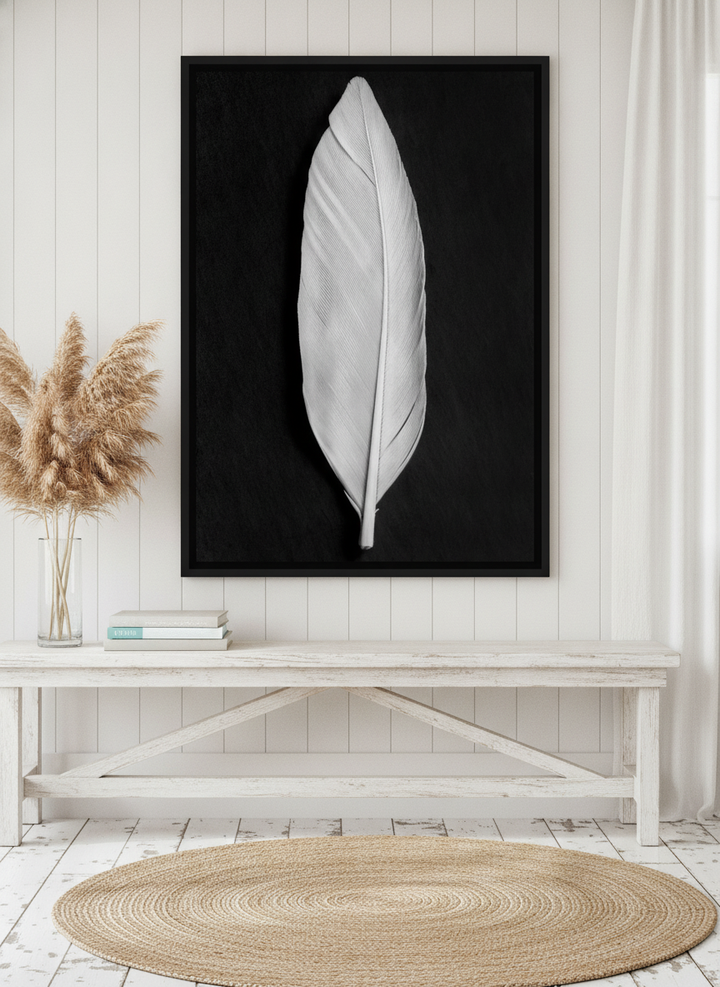 Canvas wall art with a black surround standing on a console in a coastal bathroom