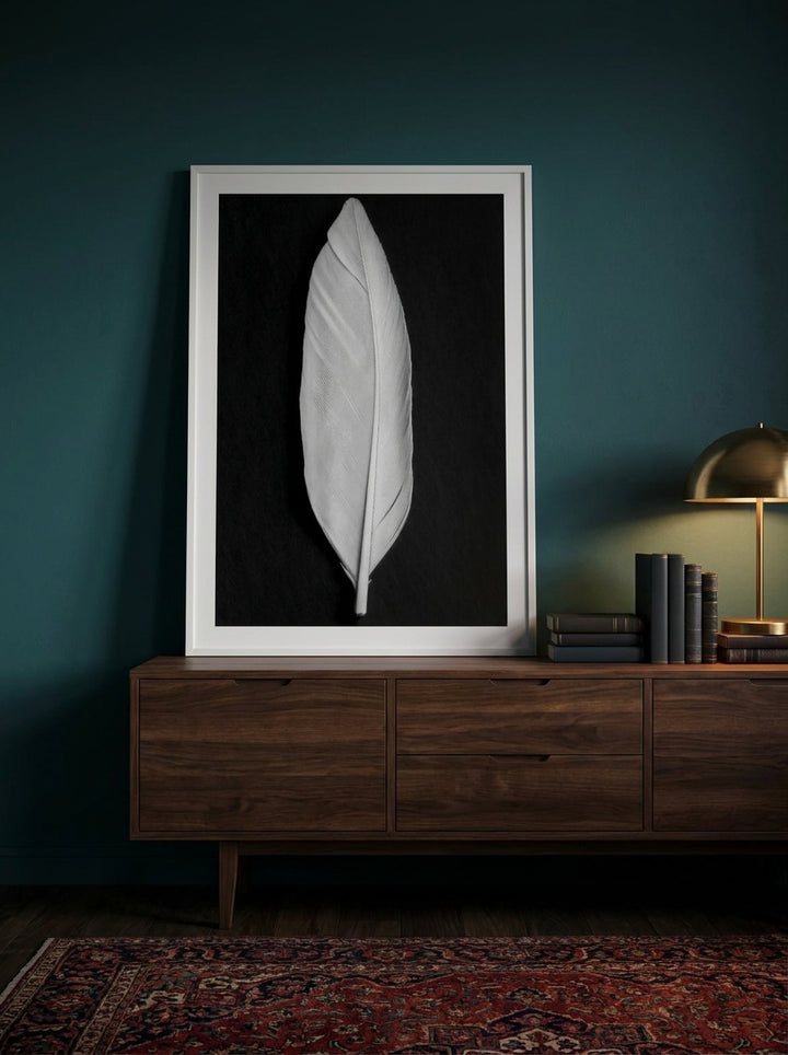 Modern wall art print standing on a sideboard in a moody home office