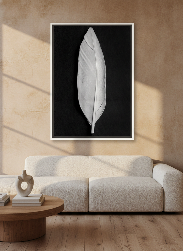 Oversized statement canvas wall art with a white surround styled on the wall in a luxe living room