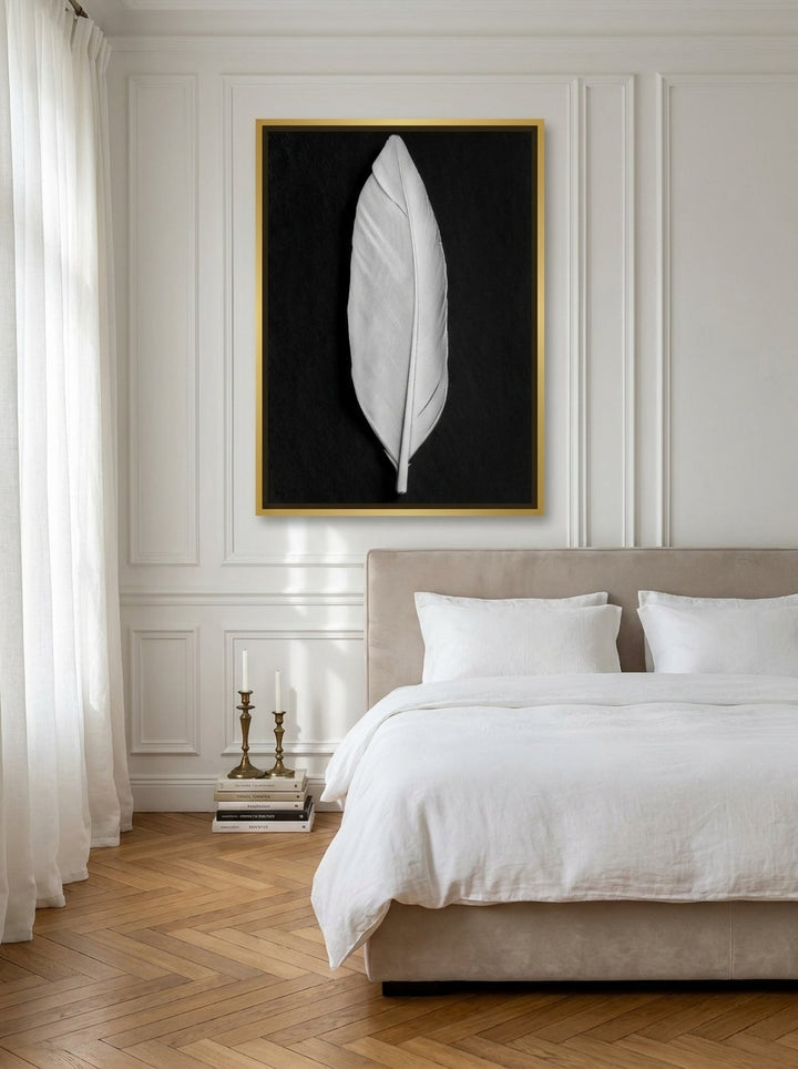 Canvas wall art with a gold leaf surround styled on the wall in a Parisian bedroom