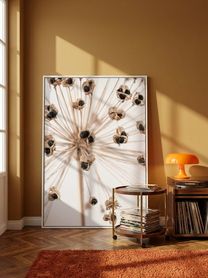 Oversized statement canvas wall art with a white surround leaning against the wall in a retro 70s dining room