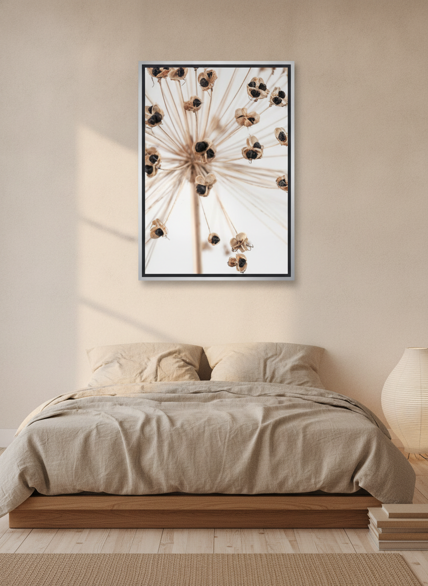 Canvas wall art with a silver leaf surround styled on the wall in a warm Japandi bedroom