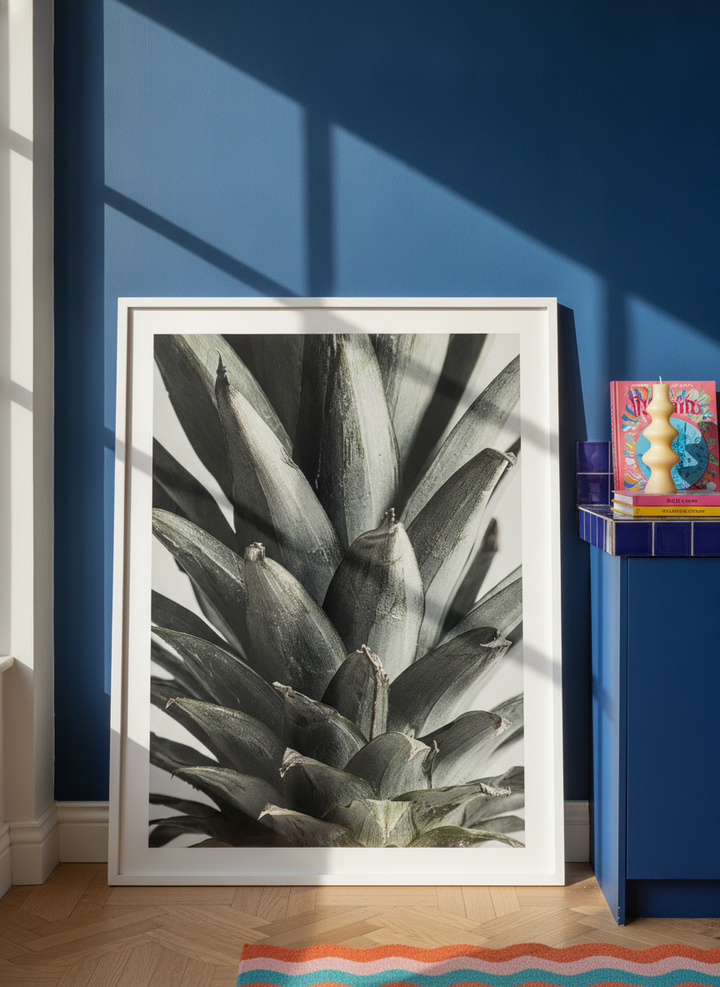 Modern wall art print standing on a kitchen bench in a colourful eclectic kitchen