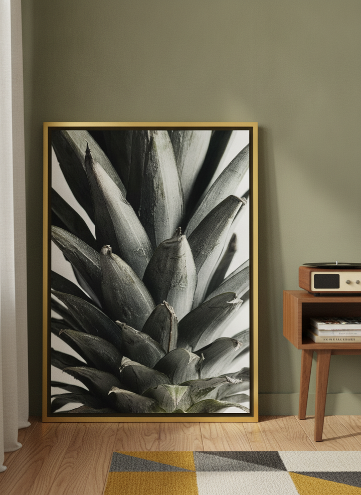 Canvas wall art with a gold leaf surround leaning against the wall in a mid-century kitchen