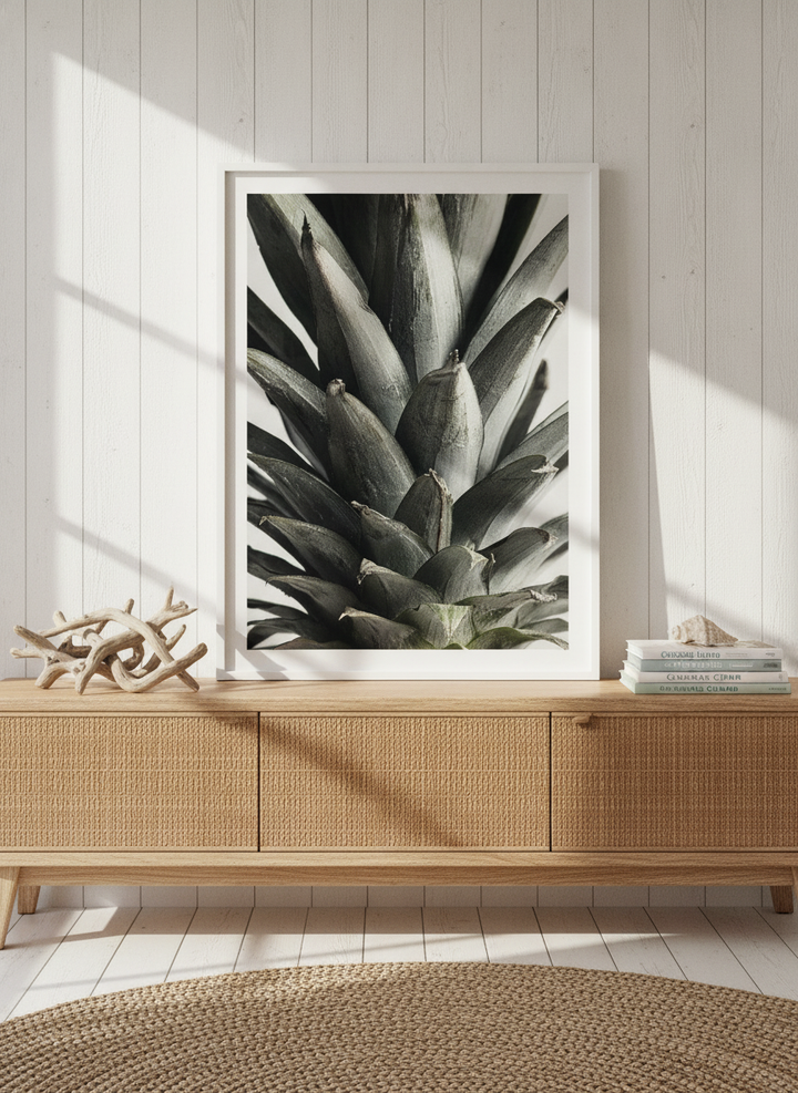 Modern wall art print standing on a sideboard in a coastal living room