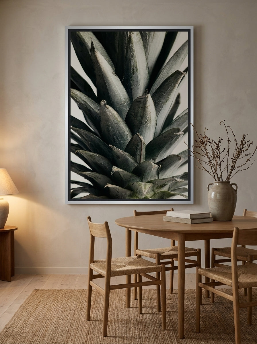 Oversized statement canvas wall art with a silver leaf surround styled on the wall in a warm Japandi dining room
