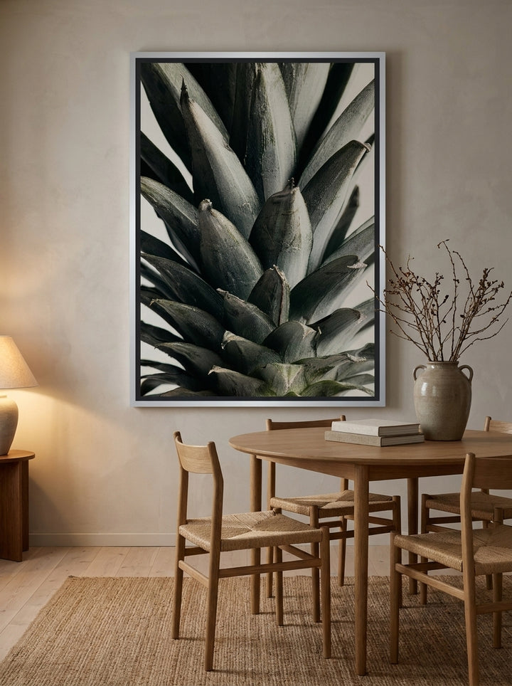 Oversized statement canvas wall art with a silver leaf surround styled on the wall in a warm Japandi dining room