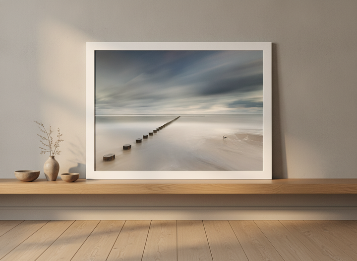 Modern wall art print standing on a shelf in a warm Japandi bathroom