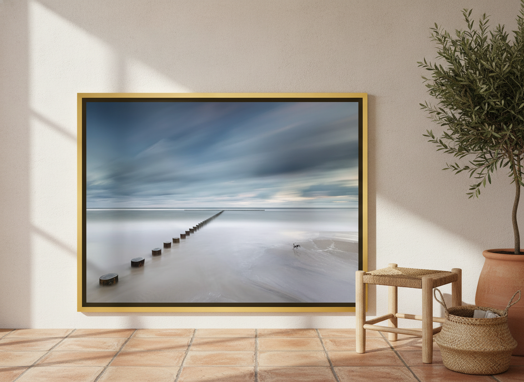 Canvas wall art with a gold leaf surround leaning against the wall in a Mediterranean bathroom