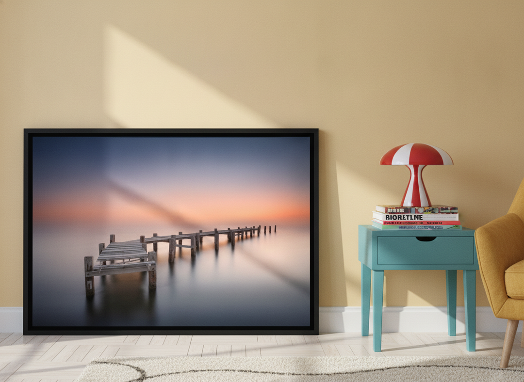 Canvas wall art with a black surround leaning against the wall in a colourful eclectic home office