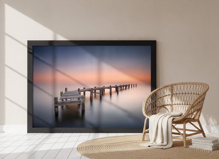 Oversized statement modern wall art print leaning against the wall in a coastal bedroom