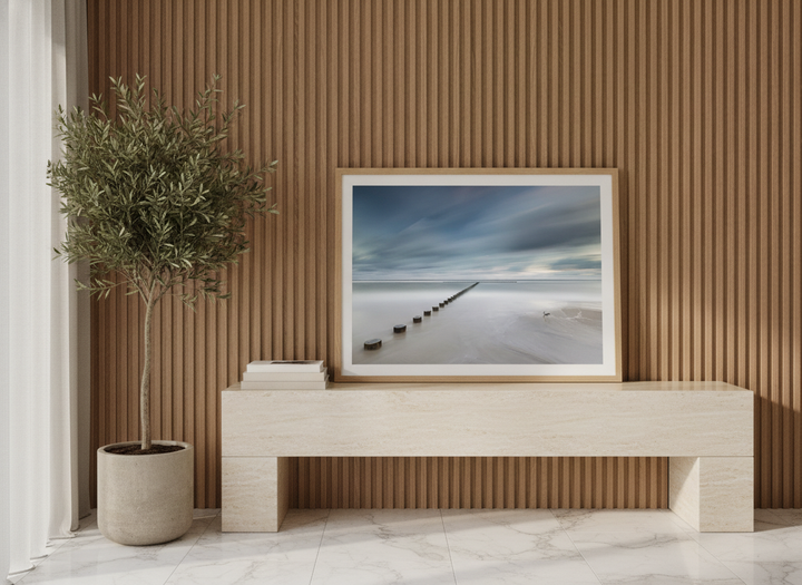 Modern wall art print standing on a console in a luxe home office