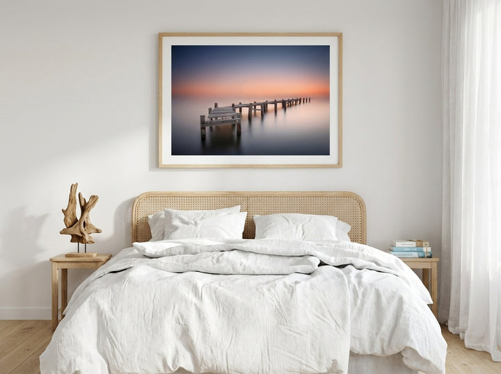 Modern wall art print styled on the wall in a coastal bedroom