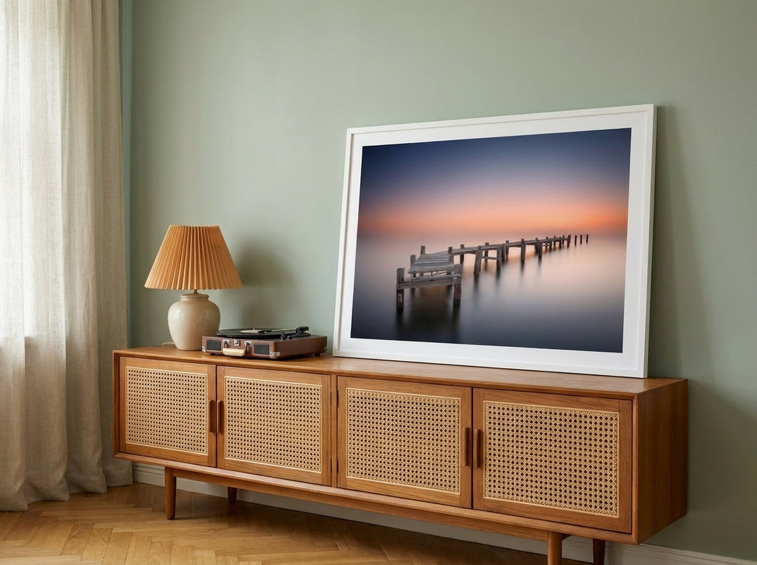 Modern wall art print standing on a sideboard in a mid-century bedroom