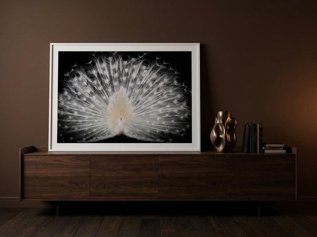 Modern wall art print standing on a sideboard in a moody bedroom