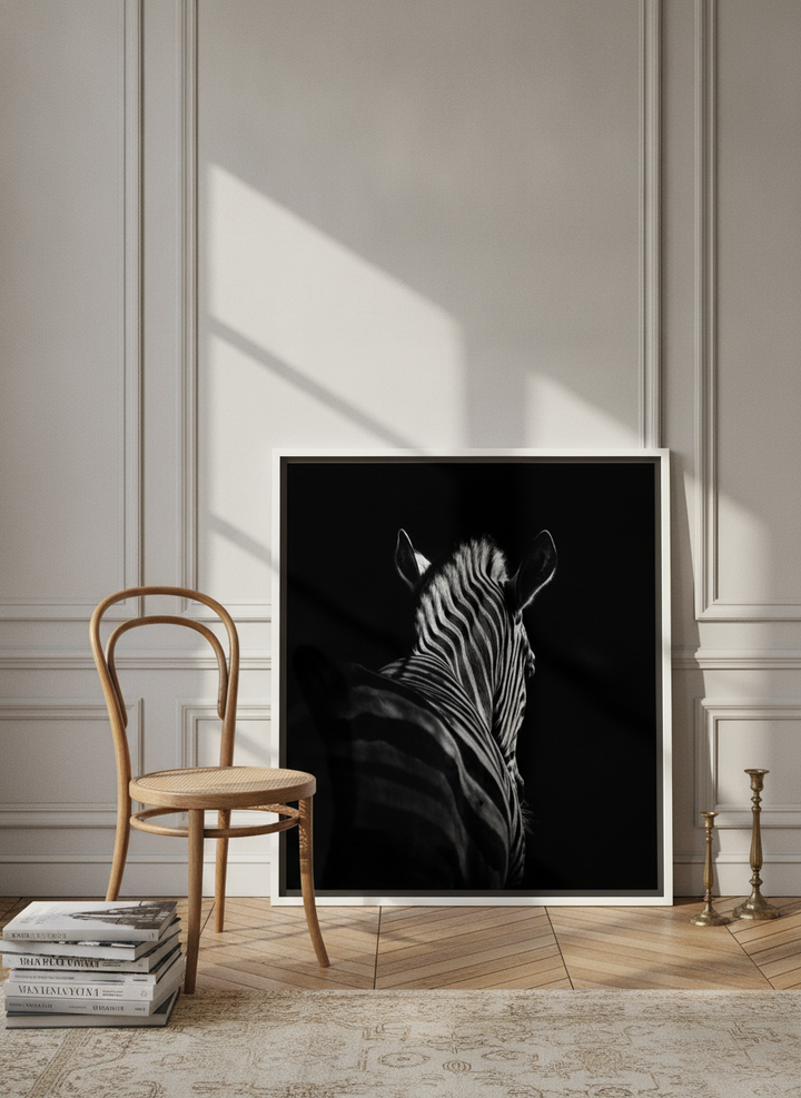 Canvas wall art with a white surround leaning against the wall in a Parisian home office