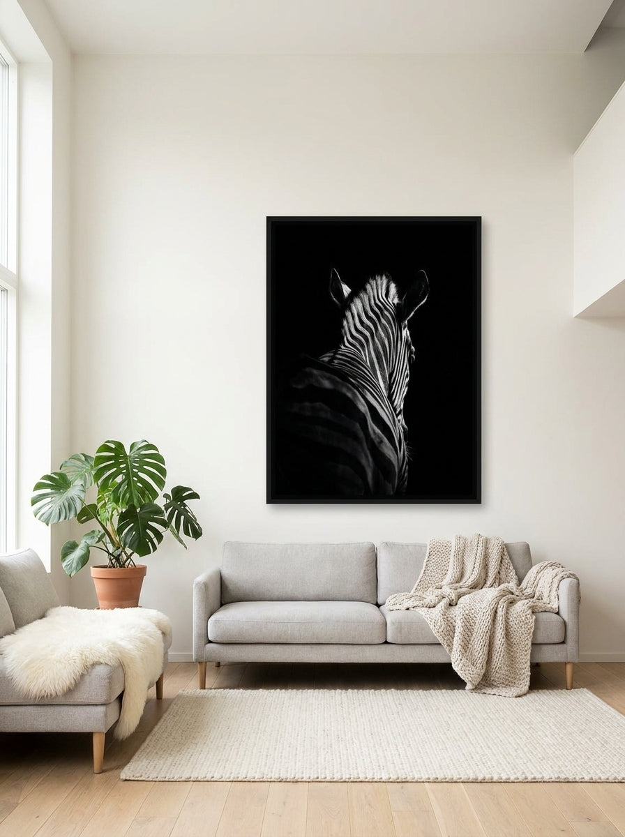 Oversized statement canvas wall art with a black surround styled on the wall in a bright Scandinavian living room